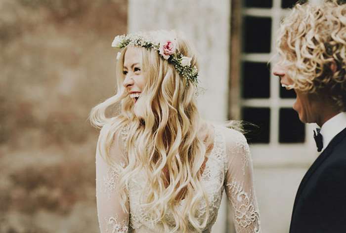 Bohemian bride with flower crown laughing with groom