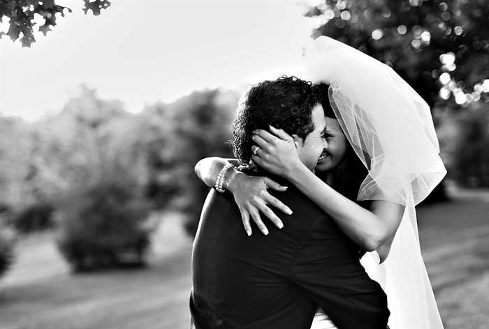 Bride with large veil hugging the groom