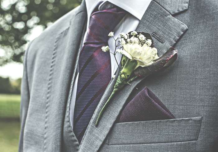 groom with purple tie