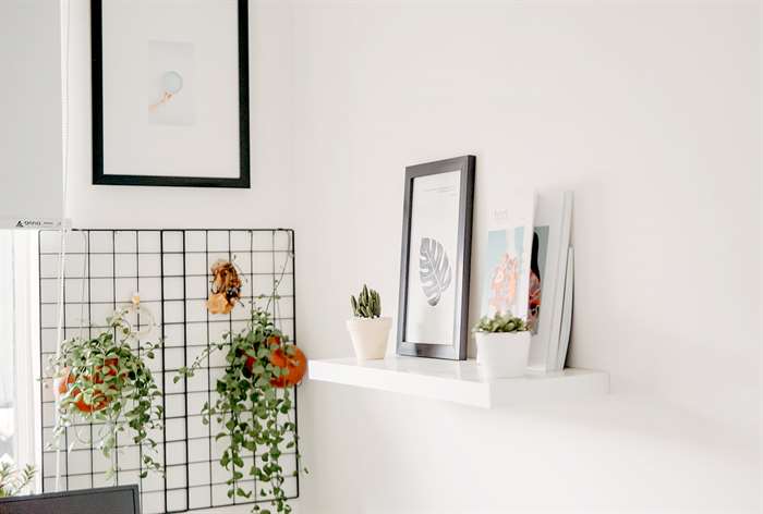 Floating shelf with picture frames. 