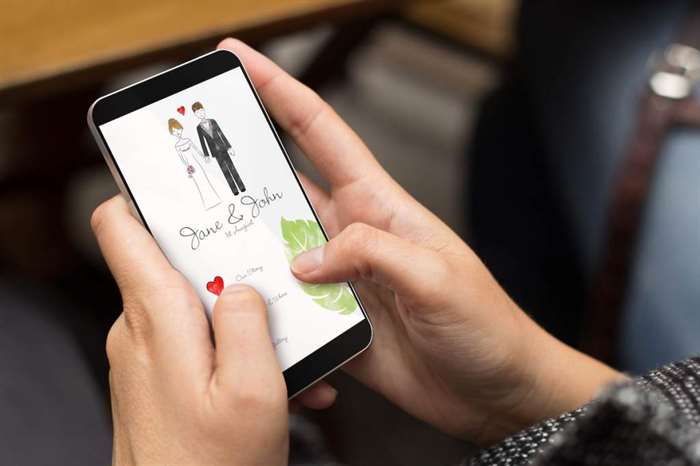 girl using a digital generated phone with wedding invitation online on the screen. This is a mock wedding websites example. 