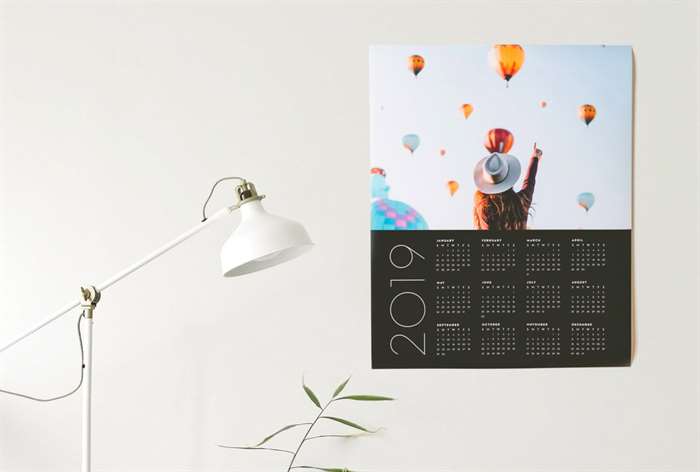 Wall calendar by white lamp. 