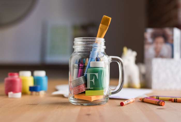 Mason jar holding art supplies.