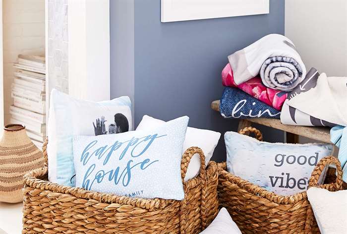 Wicker baskets with pillows and blankets.