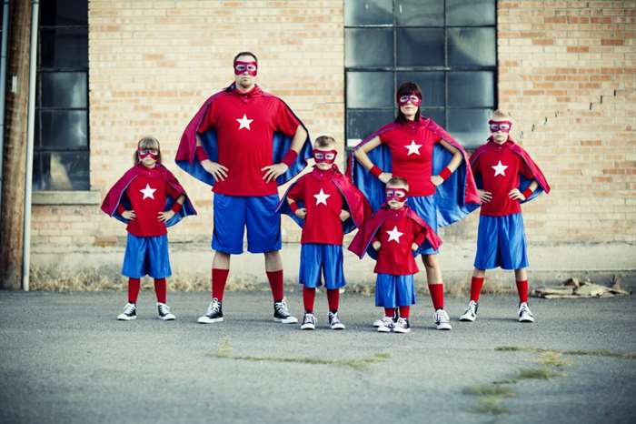 Family photo with every person dressed as a superhero.