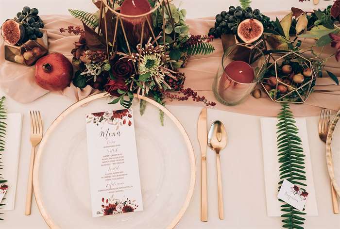 table setting at a wedding with rich red shades. 