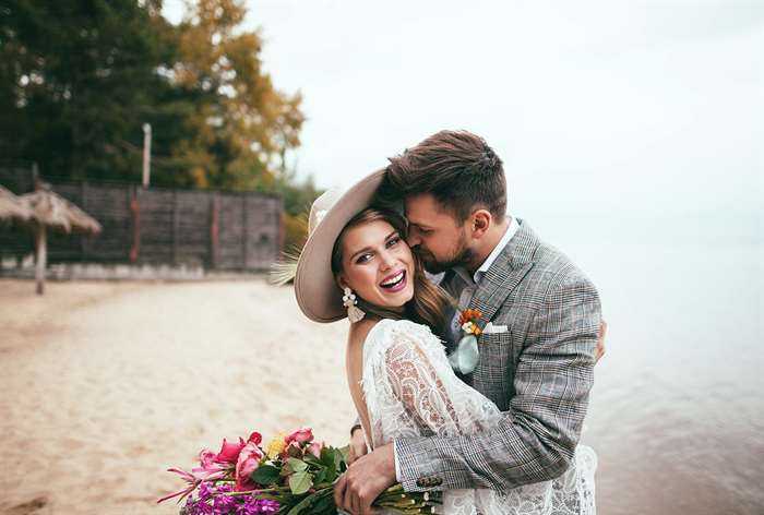 wedding invitation wording couple bride and groom on the beach