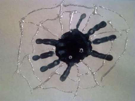 Handprint spider with glitter glue web