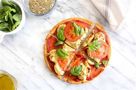 Pizza margarita thuần chay thái lát với công thức vỏ bánh socca không chứa gluten